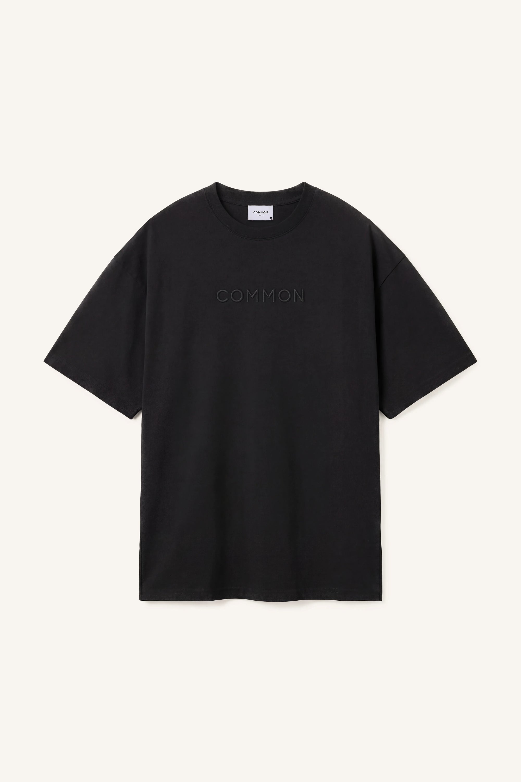 Black t-shirt with 'COMMON' branding on a white background